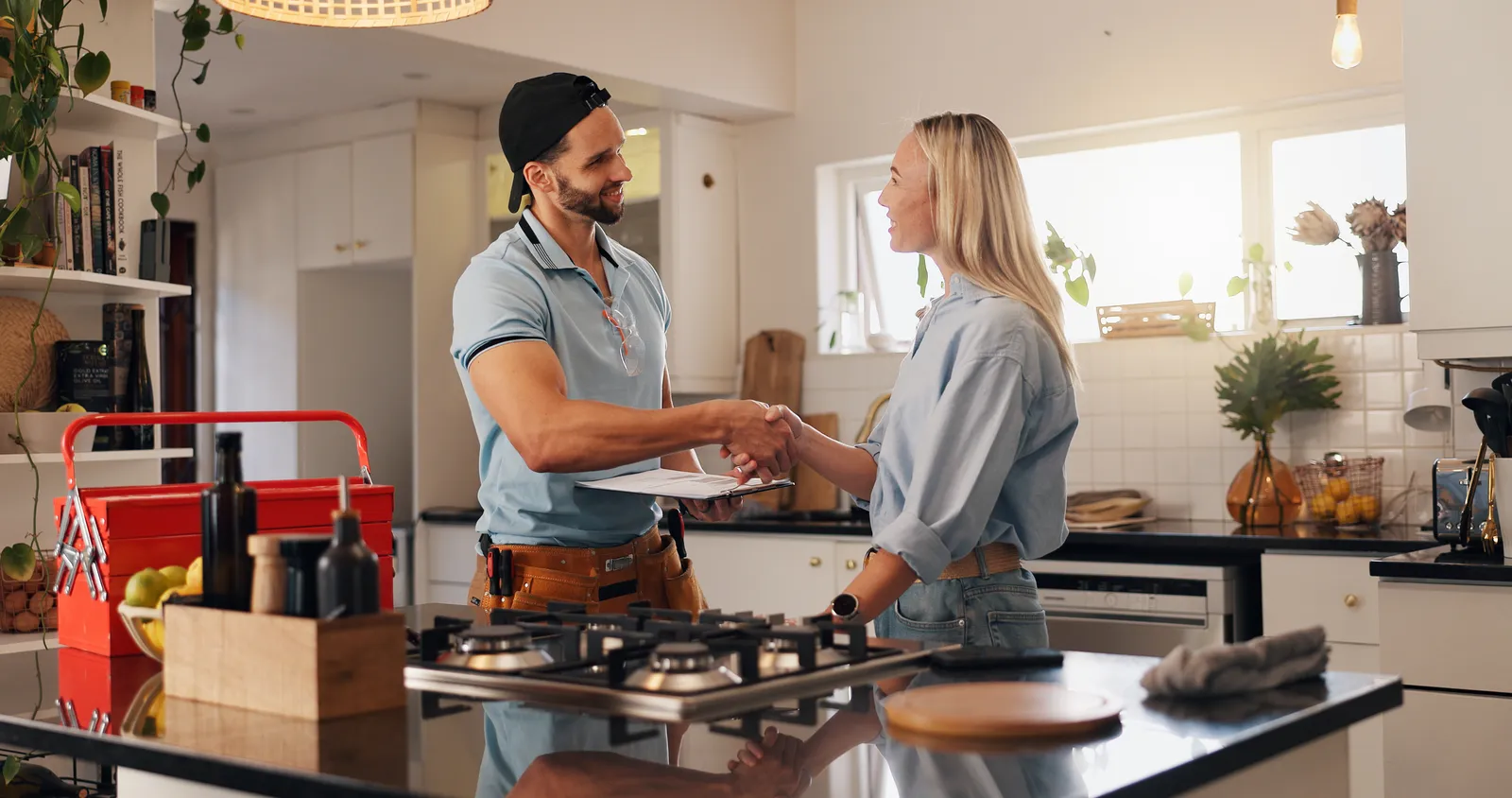 Plumber shaking hands with a happy homeowner